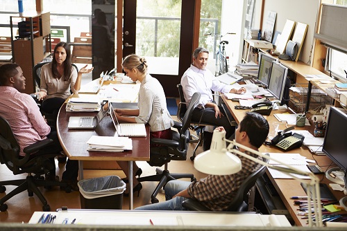 Professionals discussing 401(k) and retirement planning in an office.