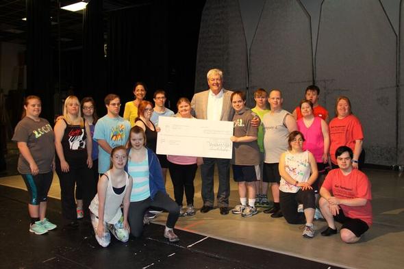 A group presentation of a donation check to Content10.