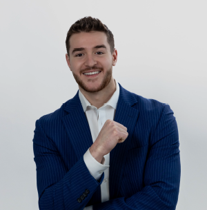 Smiling young man in a blue blazer and white shirt.