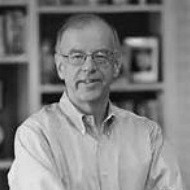 Simon Wadsworth smiling in a collared shirt.