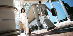 Business professionals walking with luggage at airport
