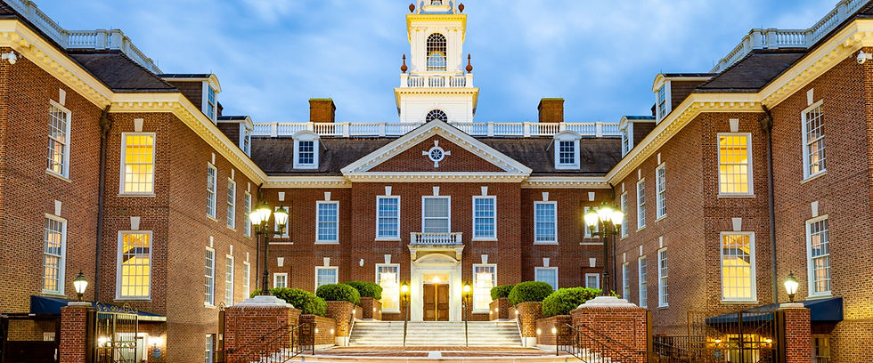 Stately brick colonial building with a white clock tower