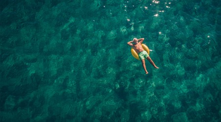 man floating relaxed on tube in the sea