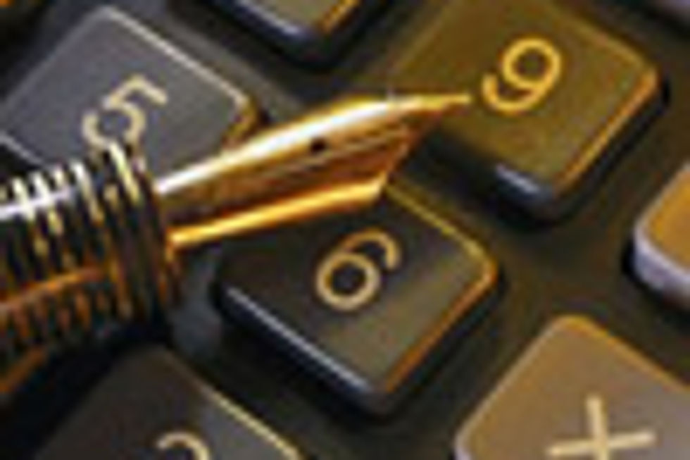 Golden fountain pen on calculator keys