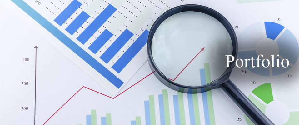 Magnifying glass over financial charts with Portfolio text