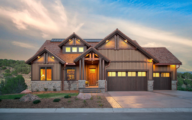 Modern family home with illuminated windows at dusk.