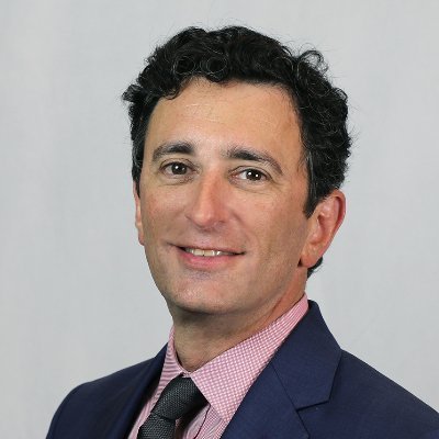 Professional headshot of a smiling male associate