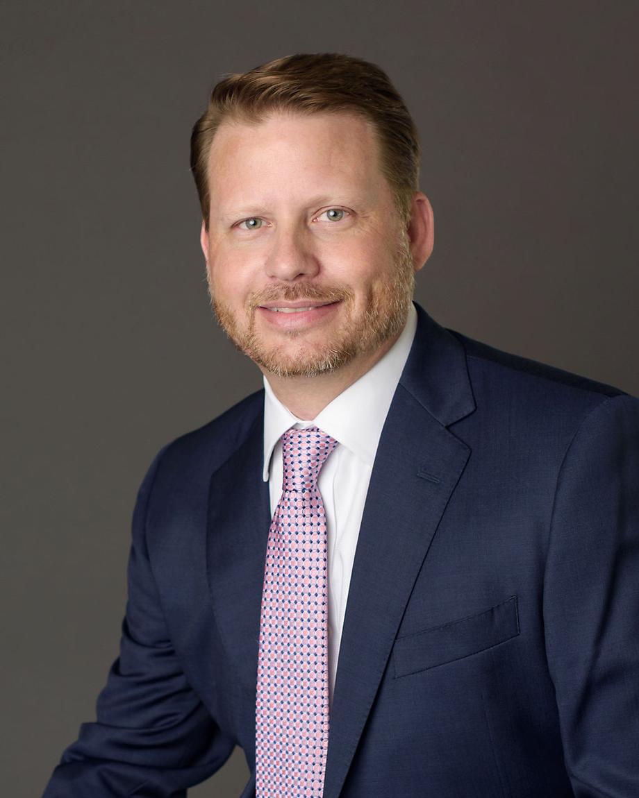 Professional portrait of a male advisor in a suit and tie