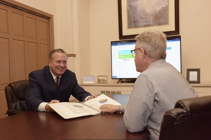Two professionals discussing a mission statement document