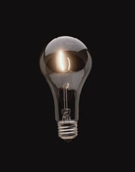 Glowing light bulb against a dark background