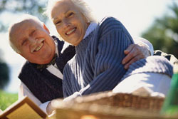 Smiling senior couple embracing outdoors