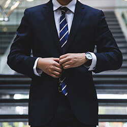 Professional in a suit adjusting his jacket