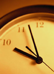 Close-up of a clock face showing the time near 11:55