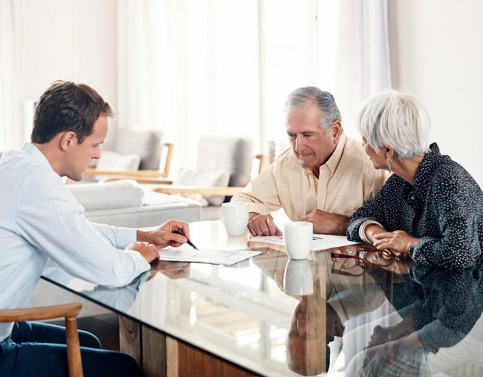 Senior couple discussing documents with a consultant.