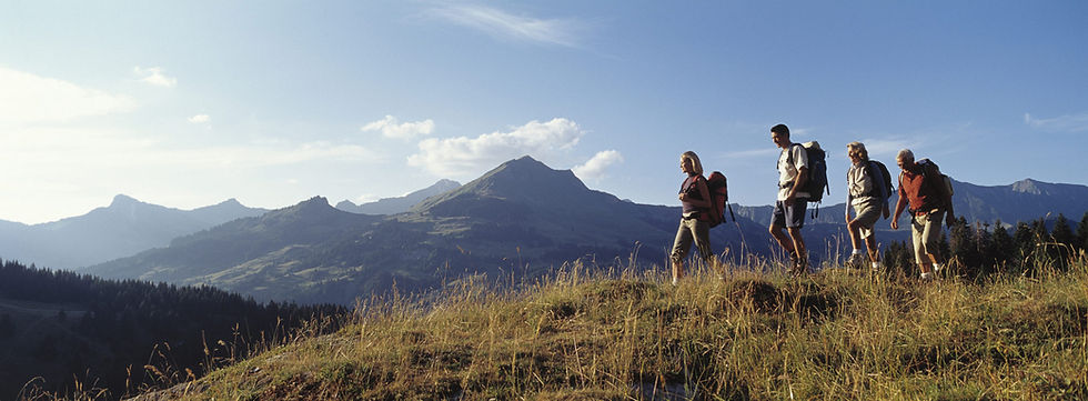 Four hikers on a mountain ridge