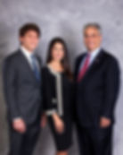 Two men and a woman in professional business attire