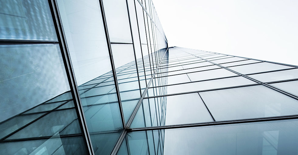 Low-angle view of a modern glass skyscraper facade