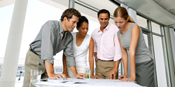 Four colleagues collaborating on a project in an office.