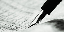 Fountain pen pointing to data in an asset management report