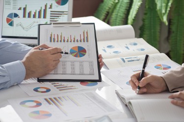 Professionals analyzing financial charts and data reports