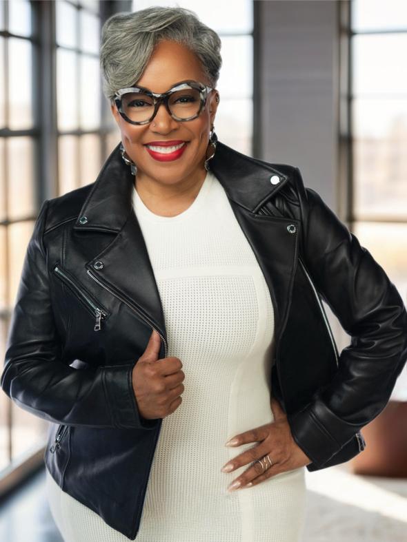 Smiling woman in a black leather jacket and white dress