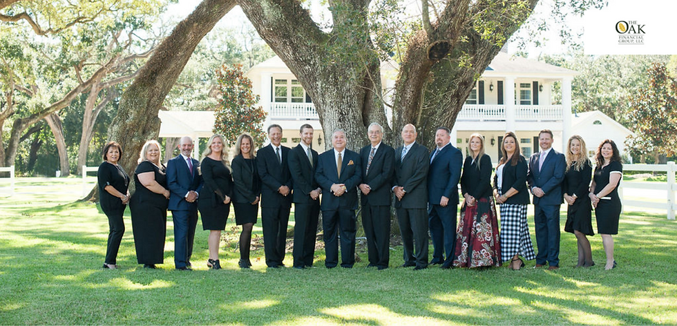 Professional team posing under a large oak tree.