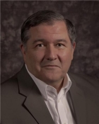 Professional headshot of a middle-aged man in a suit jacket
