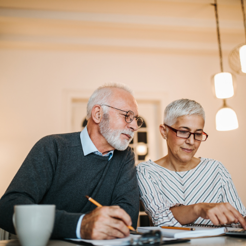 Senior couple reviewing financial documents together.