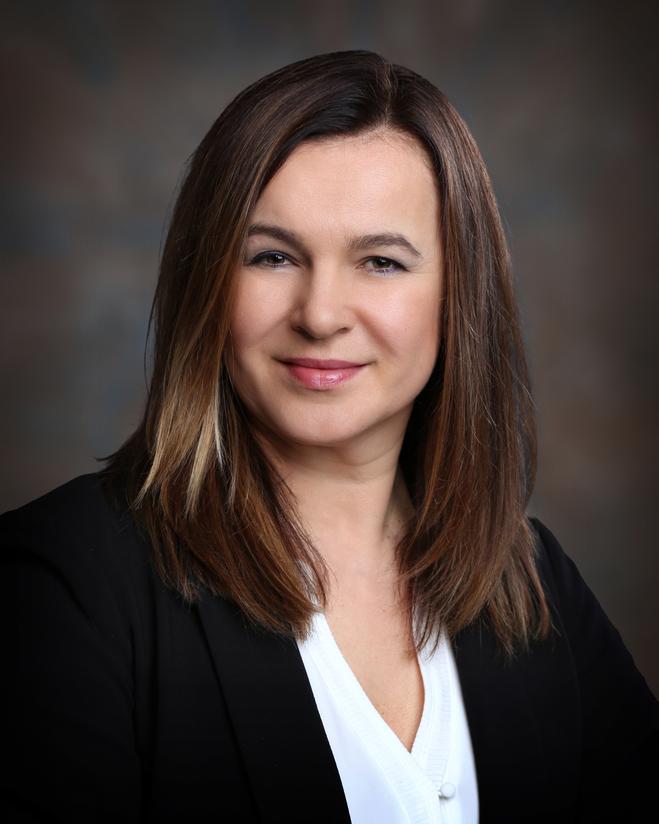 Portrait of a female team member in a black blazer.