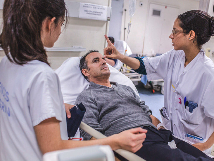 A doctor performing a neurological exam on a patient.