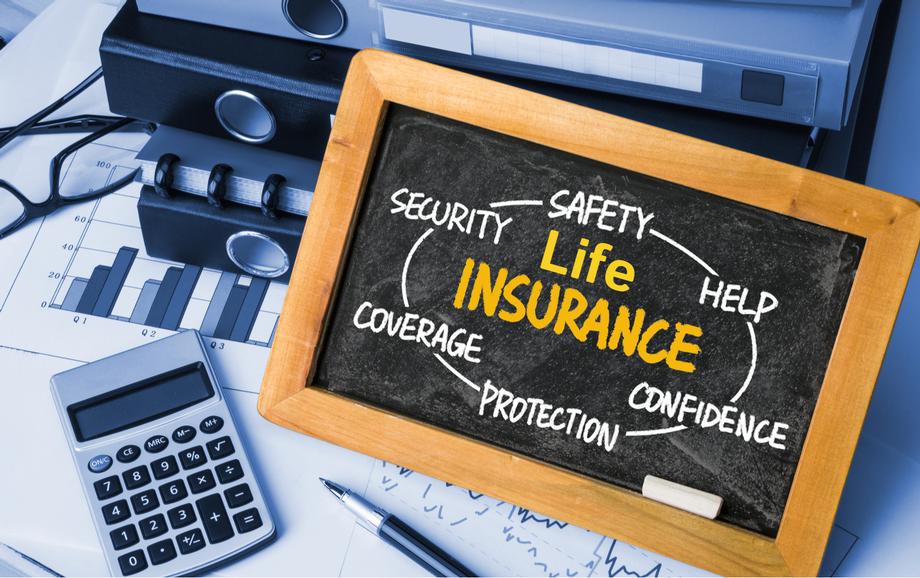 Life Insurance concept on chalkboard with calculator