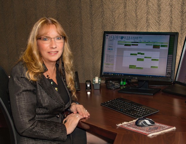 Professional woman at desk with computer during office tour