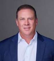 Professional headshot of a male associate in a blue blazer.