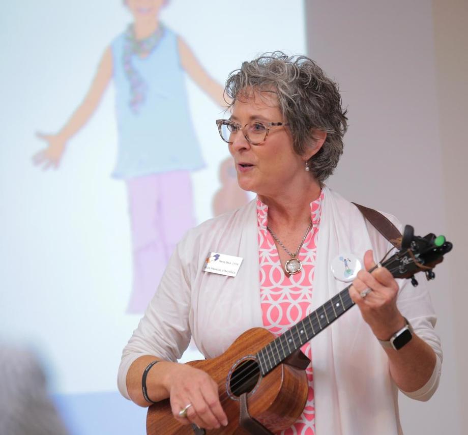Woman playing ukulele at financial empowerment workshop