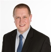 Smiling man in a suit for Farm Management expert
