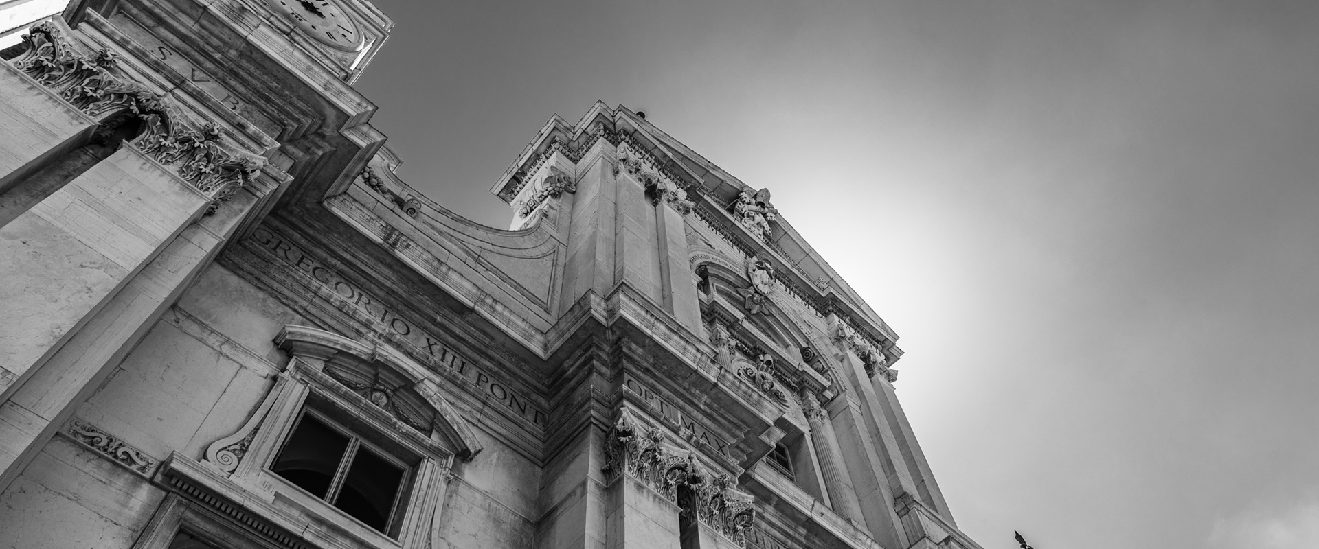 Low-angle view of a historic European facade in black and white