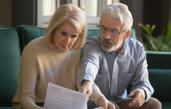 Senior couple reviewing documents for comprehensive planning