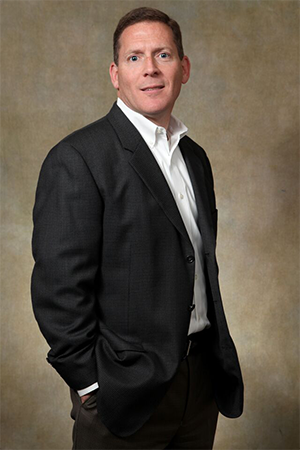 Professional man in a black blazer and white shirt.