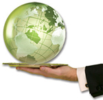 Hand in a business suit holding a green glass globe.