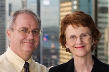 Smiling business partners in front of a city building