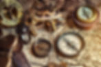 Vintage compasses, sextant, and hourglass on an old map