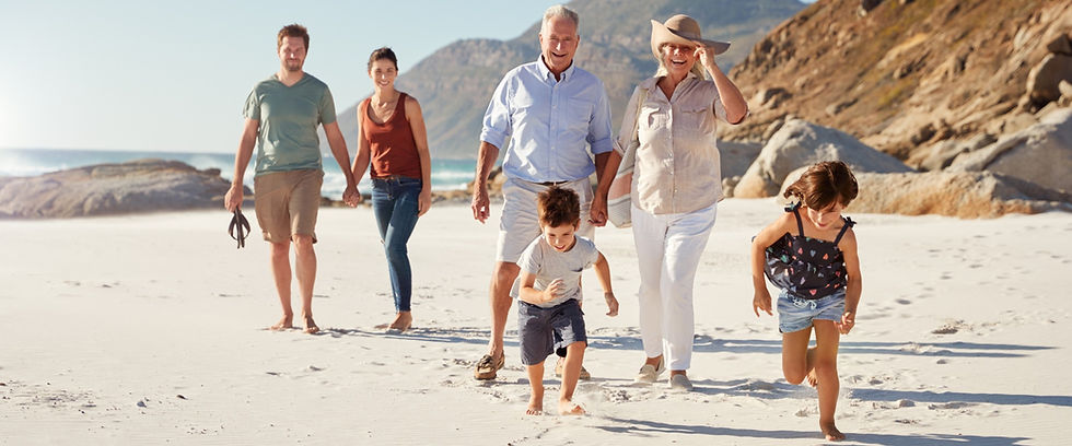 Multi-generational family walking on a sunny beach