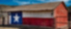 Rustic barn with Texas flag mural