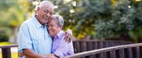 A couple smiling looking at estate planning