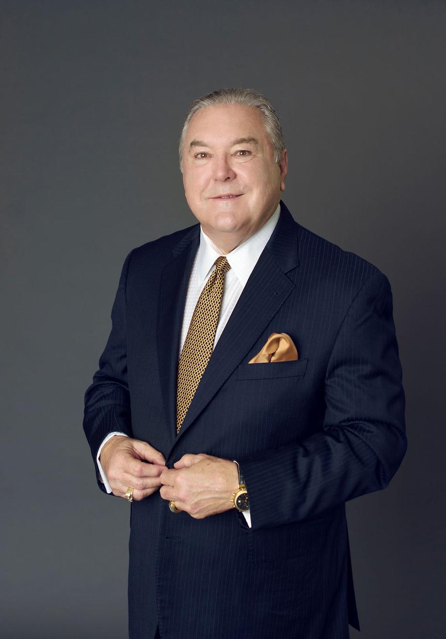 Professional portrait of a male advisor in a navy suit