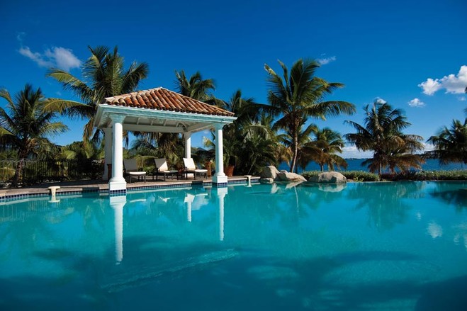Luxury resort pool with gazebo and palm trees