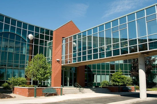 Modern brick and glass office building with skywalk
