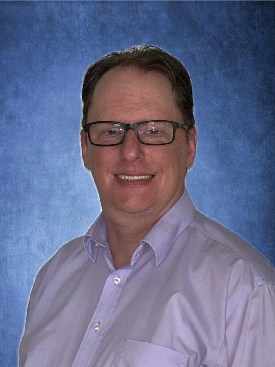 Professional headshot of a smiling male associate