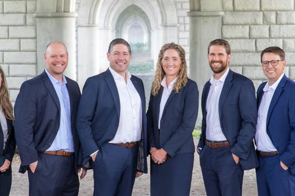 Five smiling people in business attire