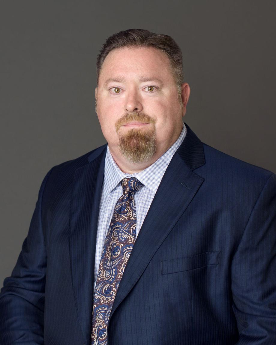 Portrait of a professional advisor in a suit and tie.